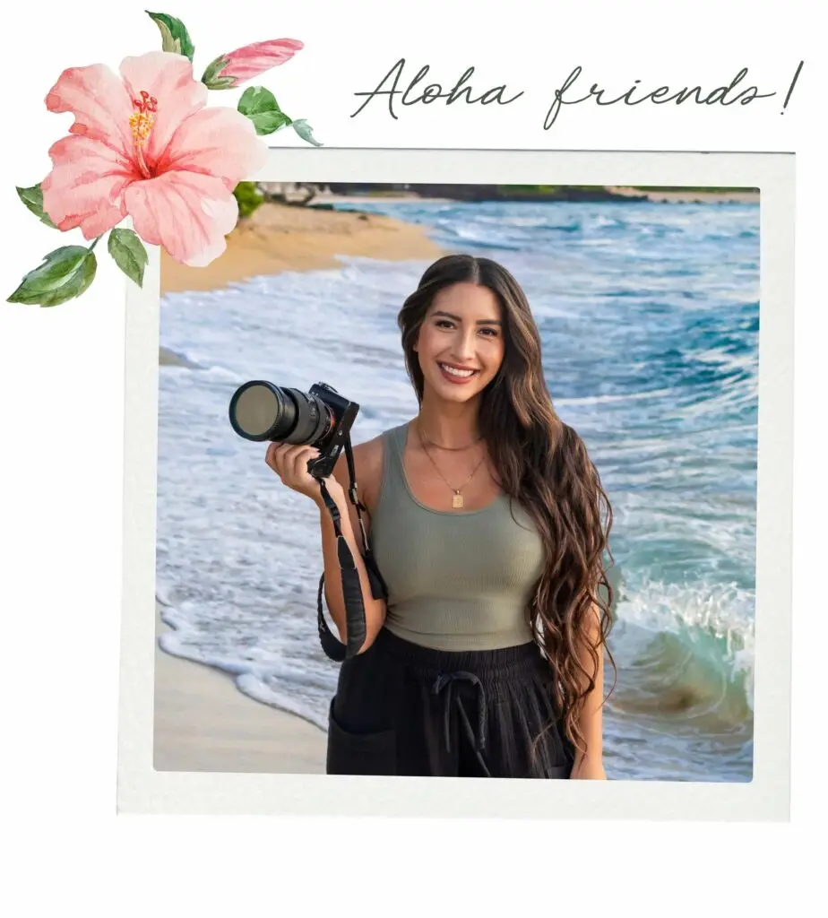 Christian Johnson, Hawaii photographer, smiling while holding her camera on the beach on the Big Island of Hawaii.