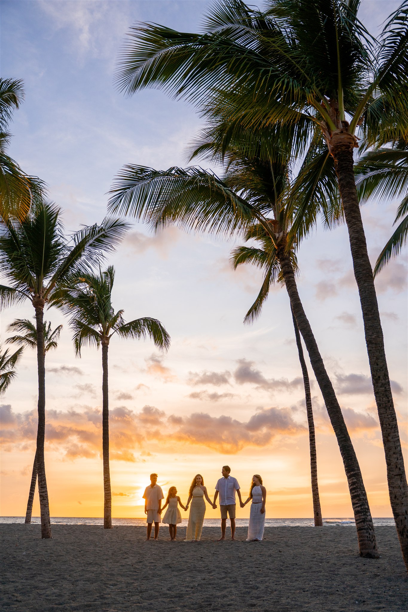 family sunset beach photography at mauna lani hotel showing poses for family photos with teenage kids