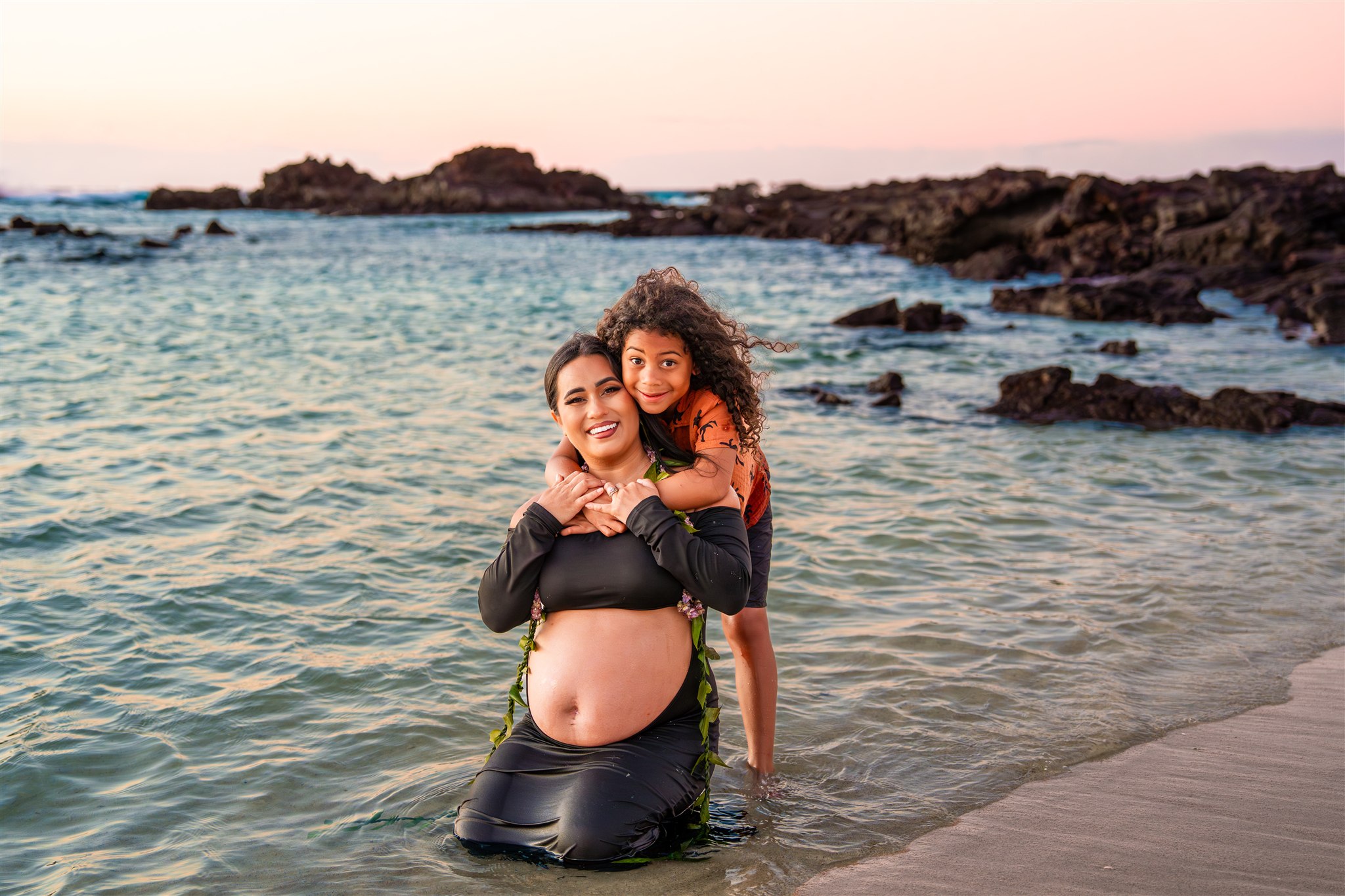 little boy hugging mother on hawaii beach by big island maternity photographer