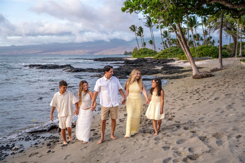 Family walking together on the beach during a Hawaii vacation.