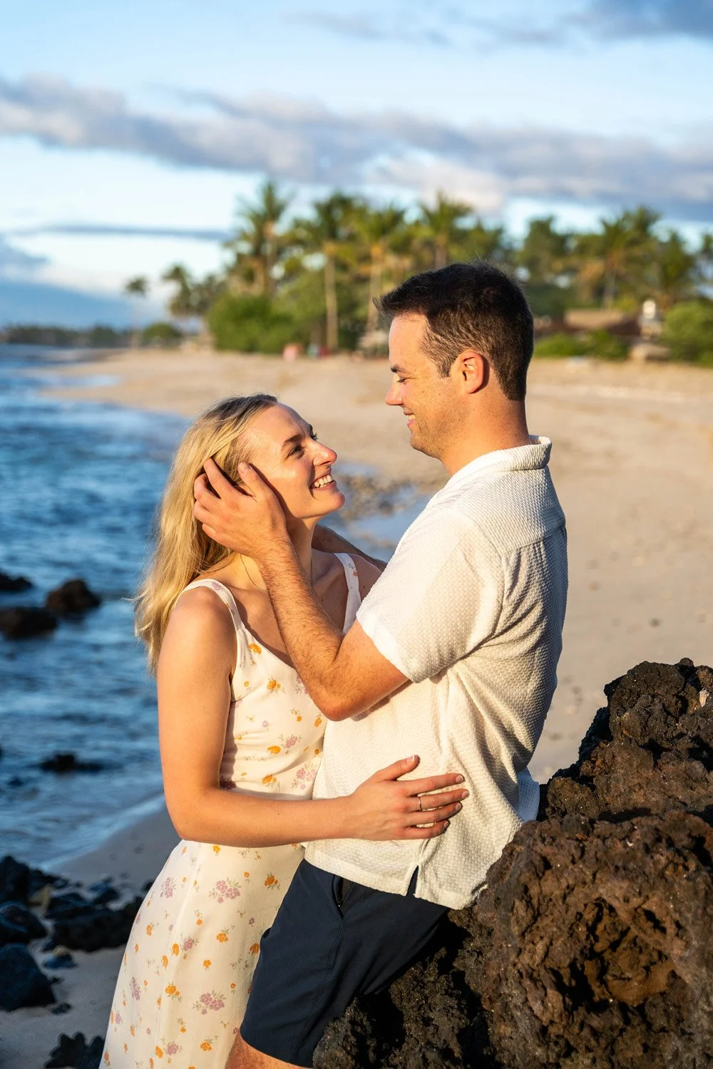 couple holding each other for an special moment after a surprise proposal at the four seasons hualalai for a couples portrait session on the Big Island of Hawaii