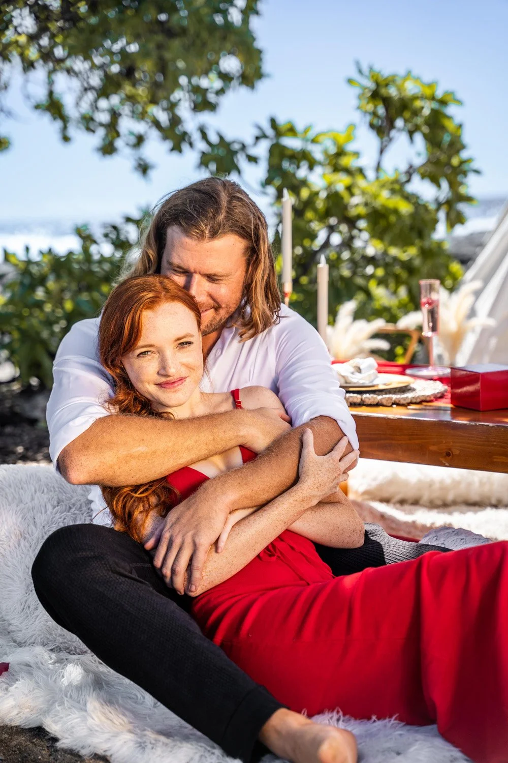 couple sitting enjoying a luxury picnic for a romantic valentines day celebration for a couples portrait session on the Big Island of Hawaii