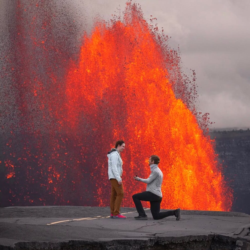 man proposing in front of lava eruption in hawaii at volcanoes national park by mountain mark photography