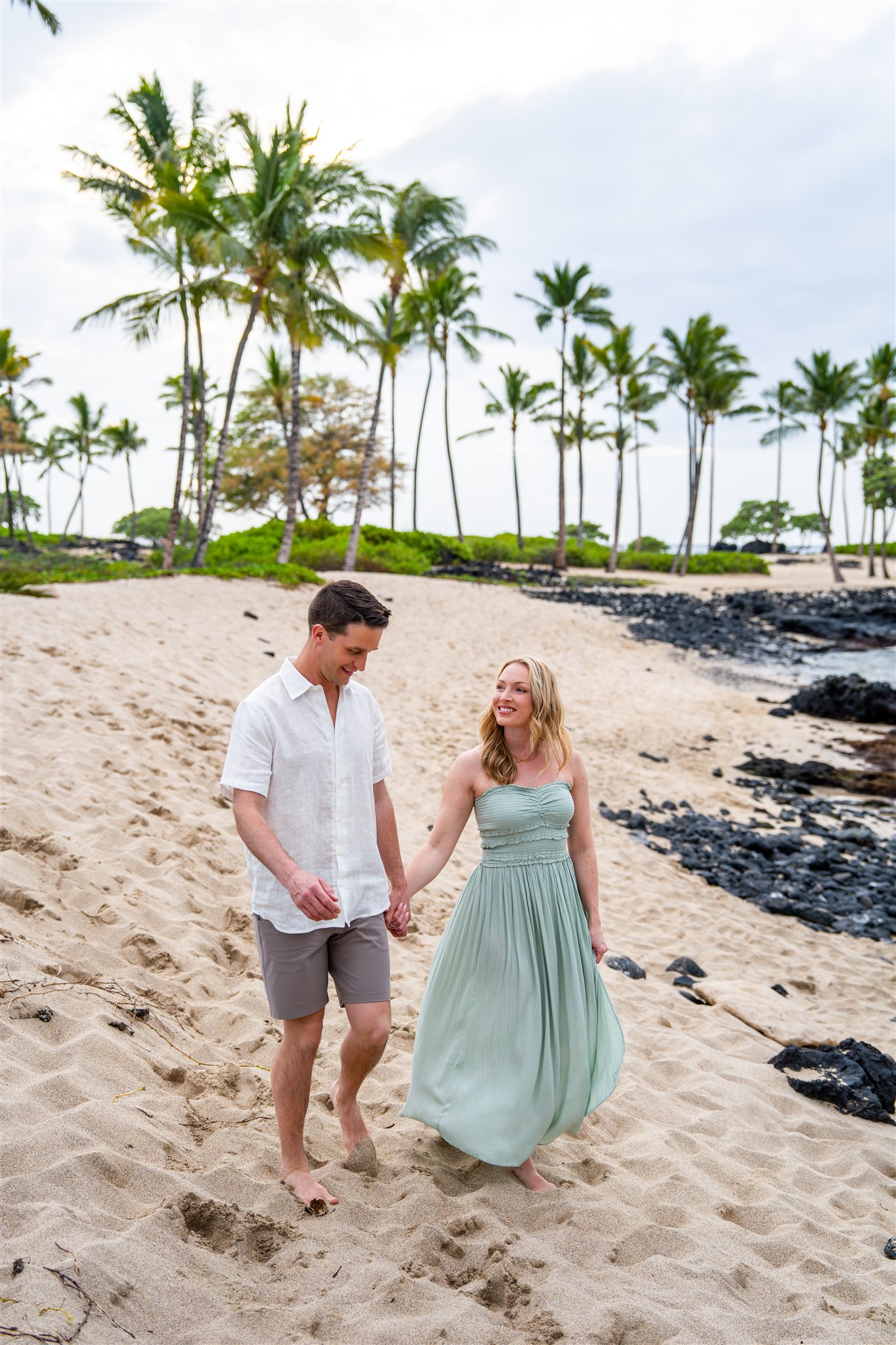 couple walking on hawaii beach big island engagement photos