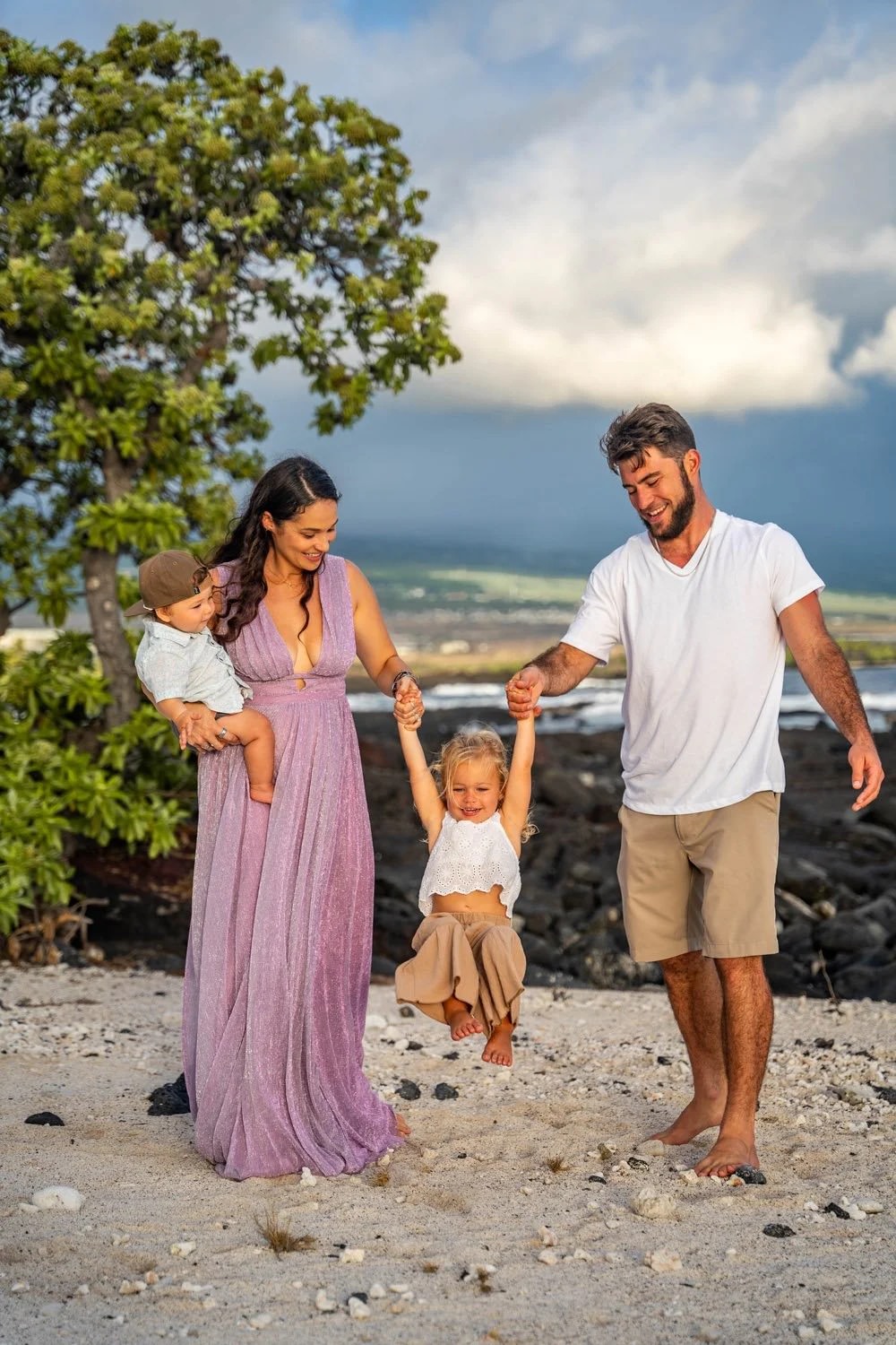 Family walking together along the shoreline during a Hawaii family photoshoot.