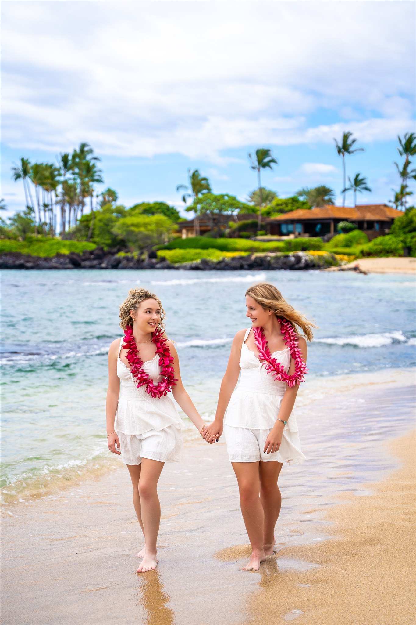 sisters holding hands for hawaii vacation family photos beach