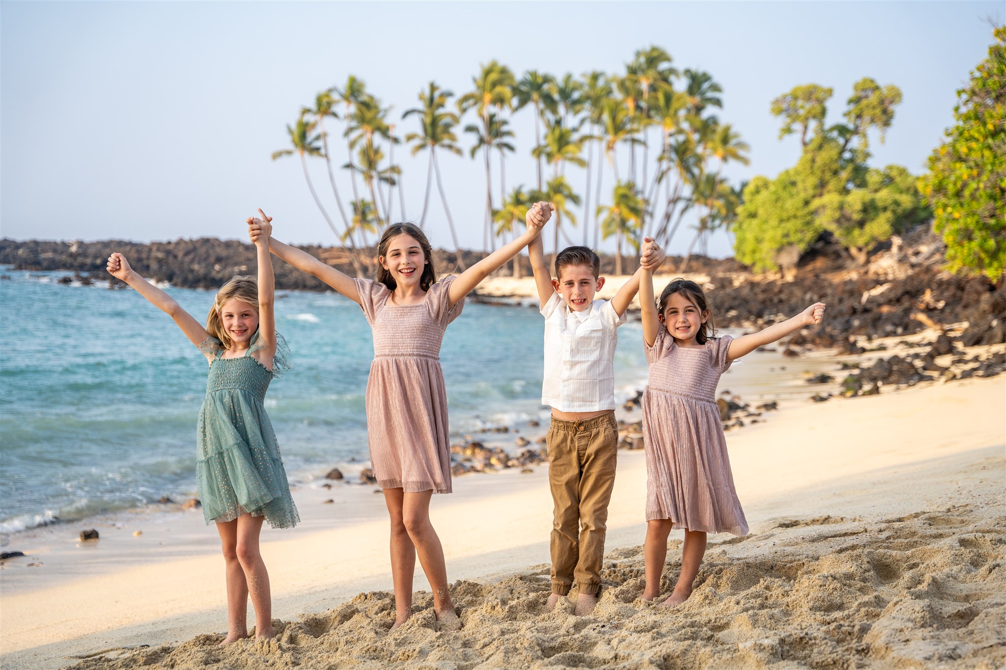 hawaii family pictures with kids holding hands on the beach