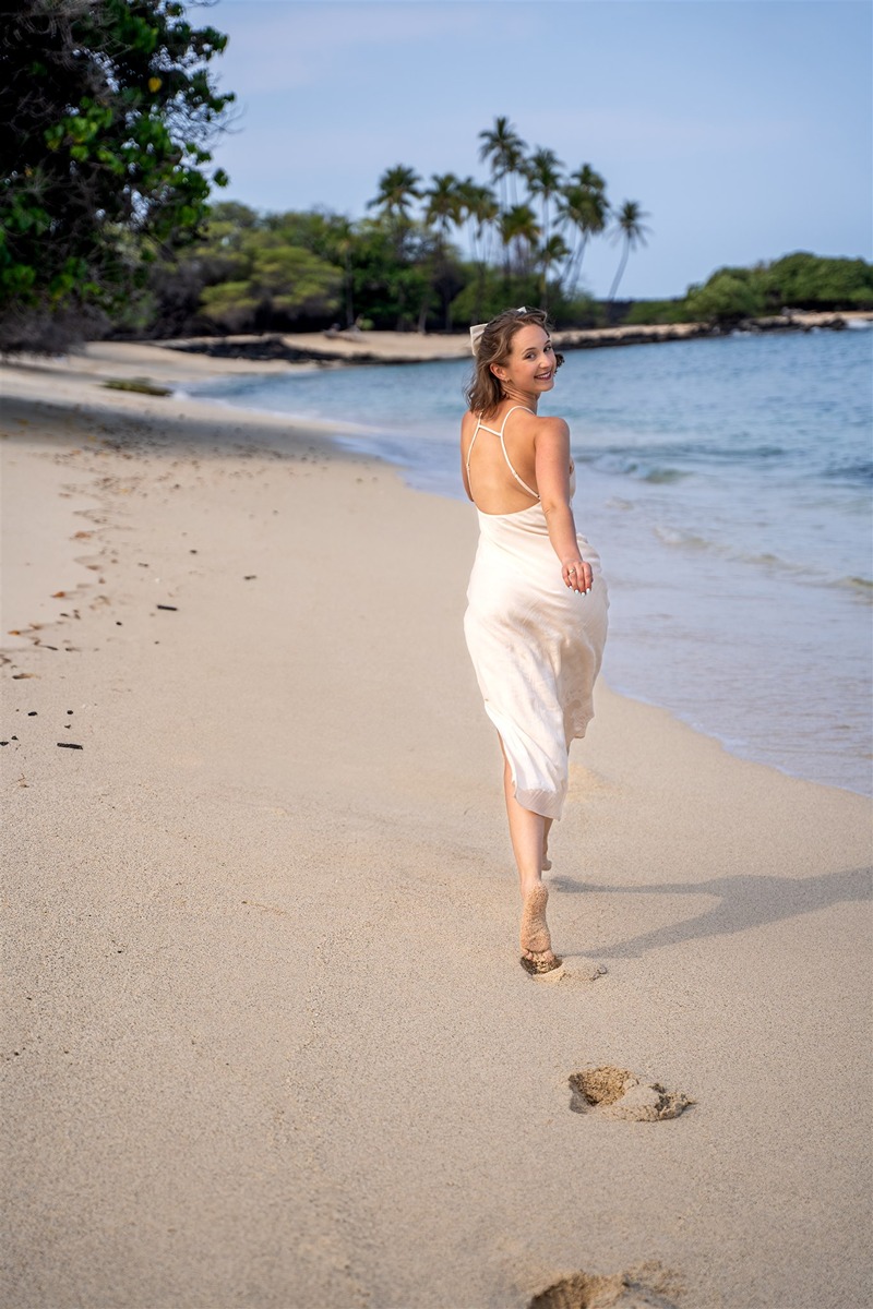 Hawaii couple photography of a girl running down the beach