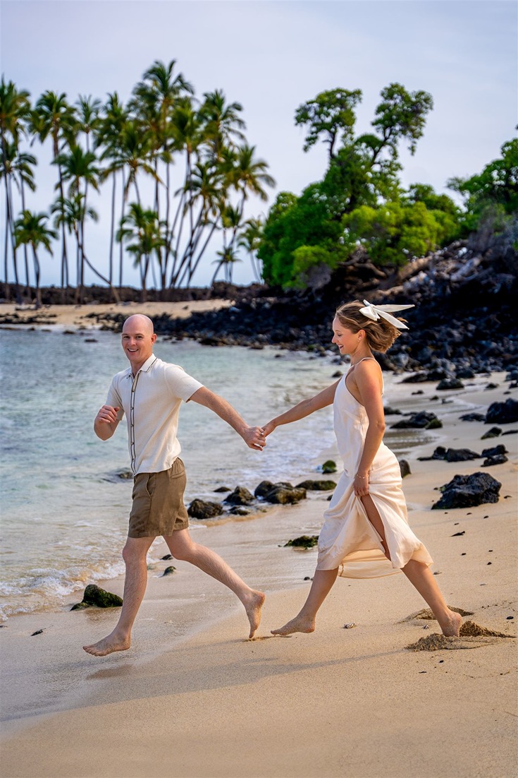 a photo of a couple running to the beach one of the best souvenir from hawaii