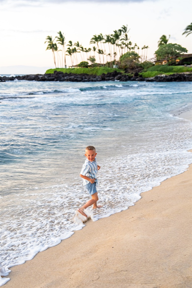 big island vacation photos of a boy running on the beach