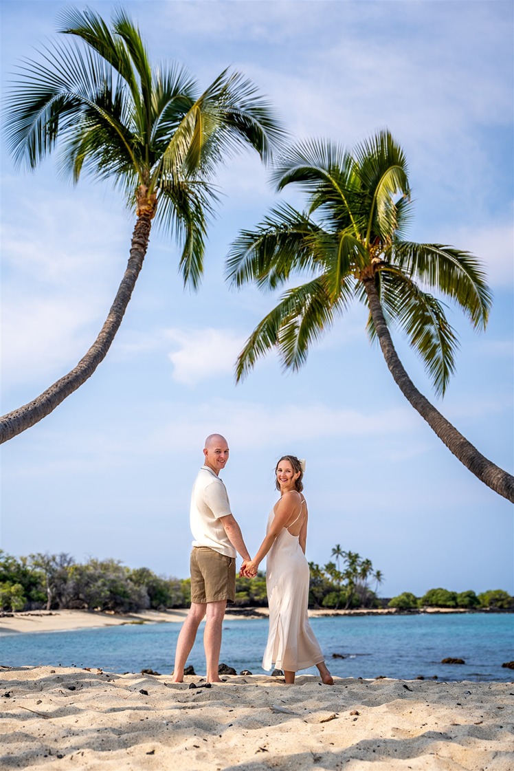 ​engagement pictures in hawaii on the beach between the palm trees