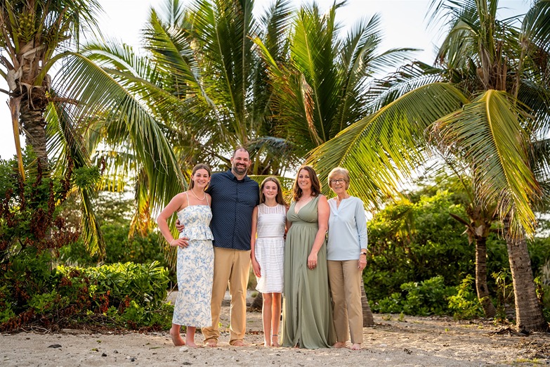 ​extended family portrait under the palm trees