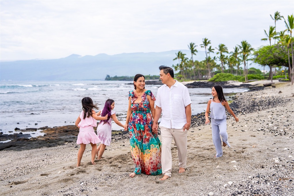 hawaii family photo of the girls running around their parents